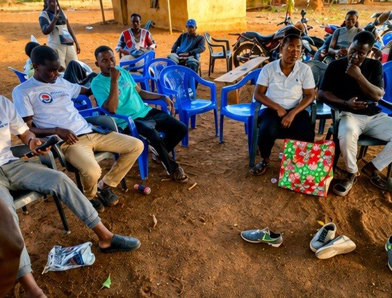 Community members seated outdoors during the donation event