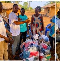 Volunteers presenting a gift to a community elder