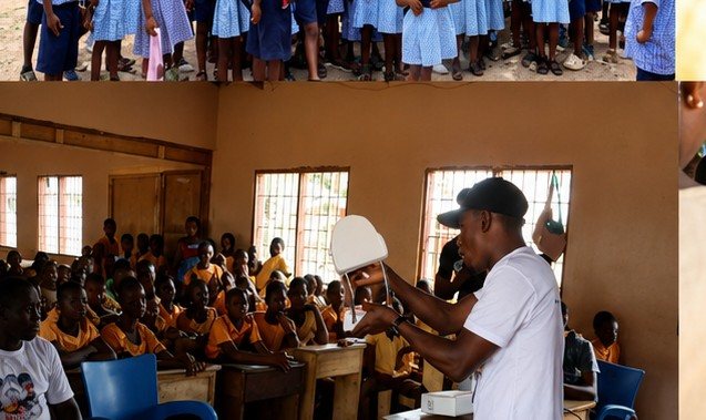 A volunteer demonstrating tooth brushing to a full classroom