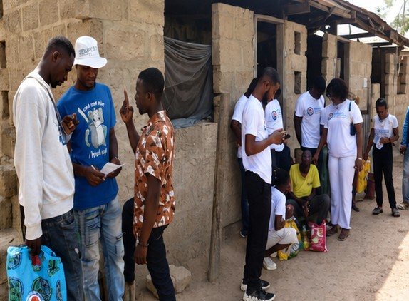 Volunteers distributing donations along a row of homes