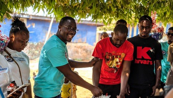 Volunteers handing gifts to community members