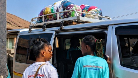 Volunteers loading donation items onto a van