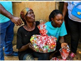 A volunteer with an elderly woman at Kpando Dafor