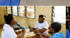 A volunteer registering a pupil at a desk