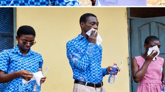 A volunteer demonstrating proper tooth brushing to students